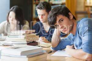 Student leaning on table looking tired