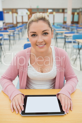 Woman sitting holding tablet pc in exam hall