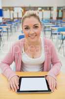 Woman sitting holding tablet pc in exam hall
