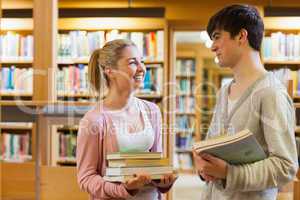 Couple smiling at each other at the library