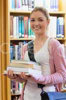 Woman smiling holding books