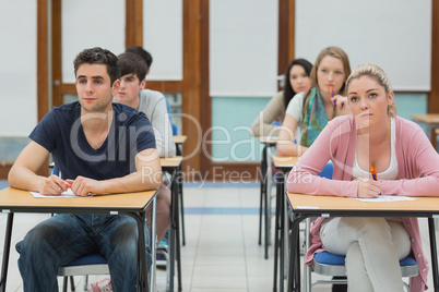 Students looking up in exam hall