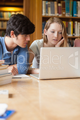 Students sitting at a laptop