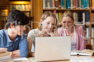 Students sitting at the library with laptop