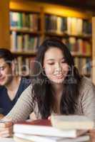 Student sitting at table smiling