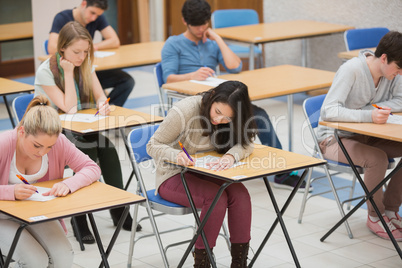 Students writing in the exam hall
