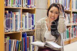 Woman getting stressed on library floor