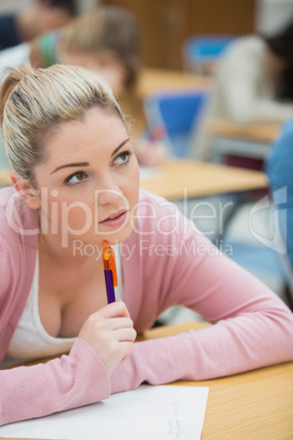 Woman sitting at desk thinking