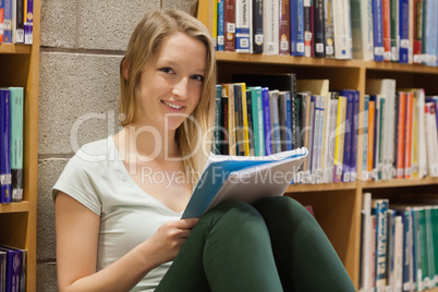 Woman sitting at the library on the floor