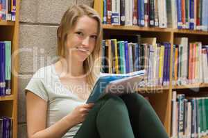 Woman sitting at the library on the floor