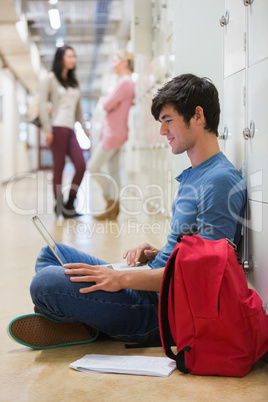 Man sitting on the floor at the hallway