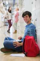 Man sitting on the floor at the hallway smiling