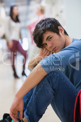 Man sitting on the floor looking