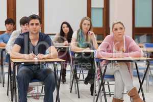 Students sitting at the classroom listening