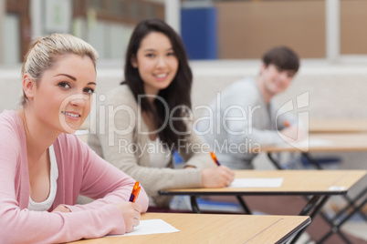 Students looking up from exam and smiling