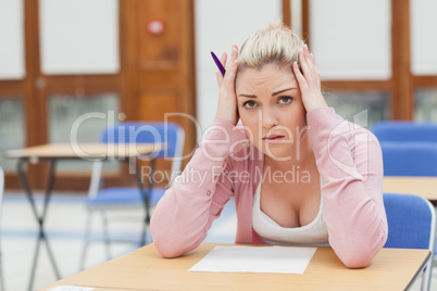 Woman looking worried over exam paper