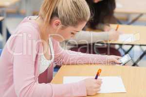 Girl is checking phone during exam