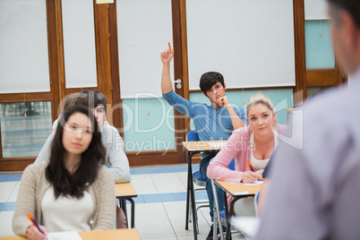 Student raising hand to ask question
