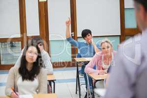 Student raising hand to ask question