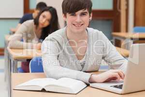 Student sitting at the classroom with laptop