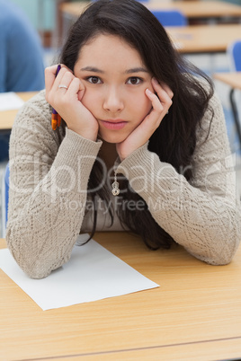 Woman with head in hands in classroom