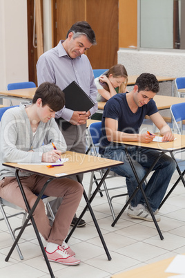 Teacher is standing next to students