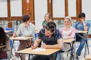 Students sitting at the exam room writing