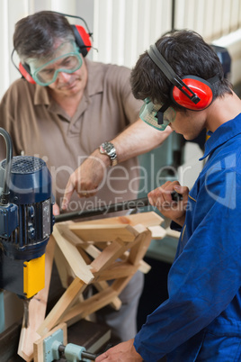 Man standing at a drilling machine