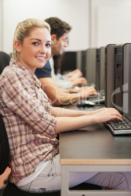 Student sitting at desk typing