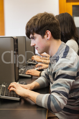 Man sitting at computer desk typing