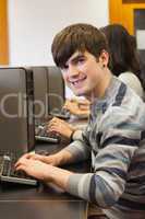 Man sitting at the computer room smiling