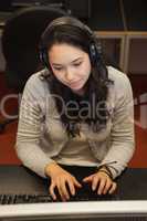 Woman sitting at the computer wearing headphones
