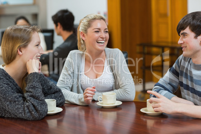 People sitting at the coffee shop smiling