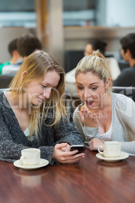 Student showing friend shocking text message