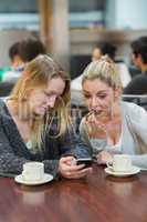 Student showing friend shocking text message