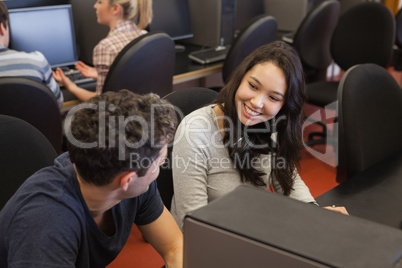 Couple sitting at the computer smiling