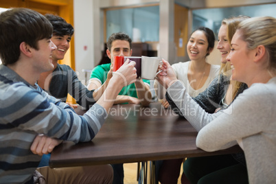 People sitting at the coffee shop clinking cups