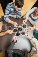 People holding up cups of coffee
