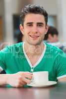 Man sitting holding a cup of coffee