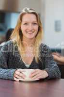 Student sitting drinking cup of coffee