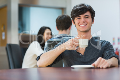 Man sitting holding cup of coffee