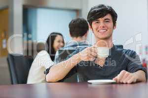 Man sitting holding cup of coffee
