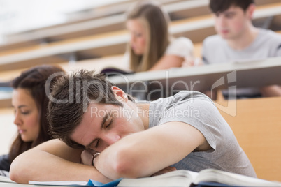 Student sitting at the lecture hall and sleeping