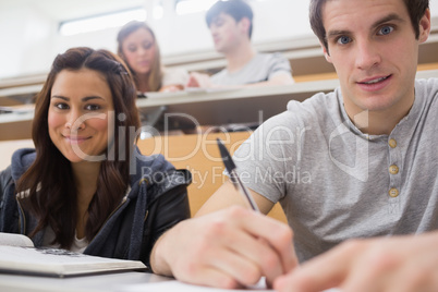 Students sitting at the desk smiling