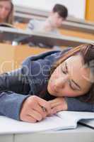 Woman leaning at the desk sleeping