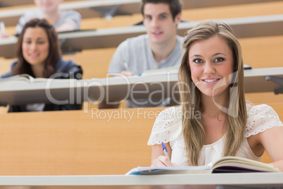 Students sitting at the lecture hall smiling