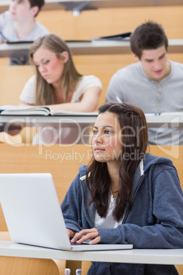 Girl sitting at the lecture hall concentrating