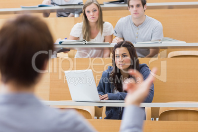 Students sitting listening to the teacher