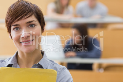 Teacher standing at the lecture hall smiling