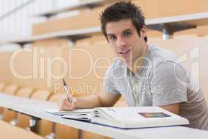 Student sitting at the desk smiling